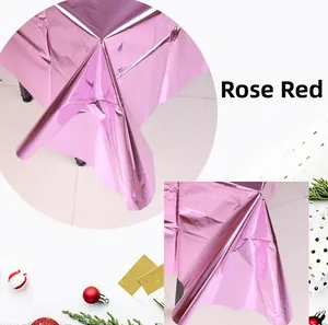 Close-up of shiny rose red metallic foil tablecloth with reflective texture for parties