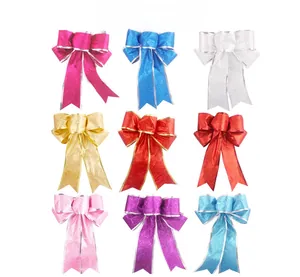 Detail view of nine colorful 25cm Christmas bows with glitter finish and long ribbons