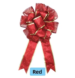 Detail of a large red Christmas bow featuring glittery fabric and gold metallic edges