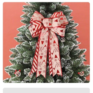 Detail of Christmas tree topper bow with vintage red elk and snowflake patterns