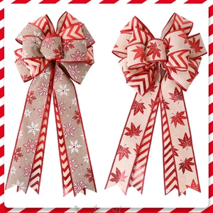 Detail of Christmas bows with snowflake and maple leaf patterns on rustic fabric textures
