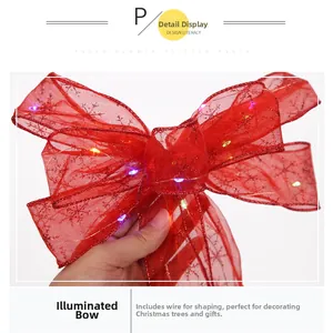 Detail view of red mesh LED ribbon bow with silver snowflake patterns and inner wire