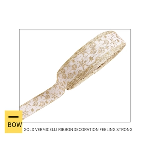 Detailed view of white Christmas ribbon with gold glitter snowflake prints and sewn edges