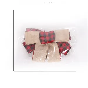 Detail view of red and black plaid Christmas bow with size dimensions 23cm by 17cm