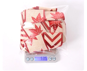 Weight measurement of red maple leaf print jute Christmas ribbon on electronic scale