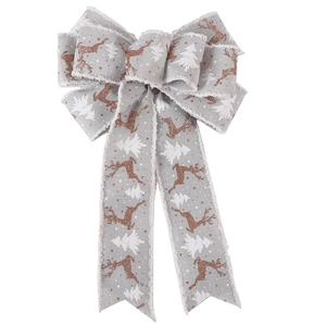 Detail of Christmas bow with rose gold reindeer glitter and white tree on grey linen