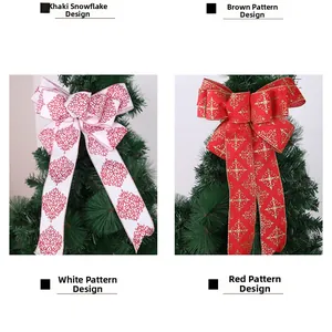 Detail of faux linen Christmas bows with red snowflake patterns on festive tree branches