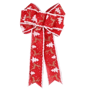 Detail of red Christmas bow featuring gold reindeer prints and white plush trim