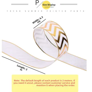 Detail of 6.3cm wide white Christmas ribbon with gold wave pattern and wire edge