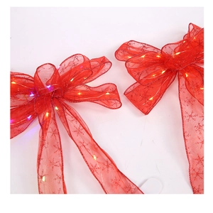 Close-up of red Christmas ribbon bows with LED lights and snowflake patterns