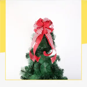 Detail of red and white wave pattern Christmas bow topper on a festive tree