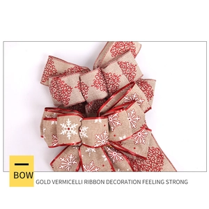 Detail of faux linen Christmas bow with red snowflake patterns and festive ribbon texture