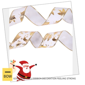Close-up of white Christmas ribbon with gold foil reindeer and forest patterns