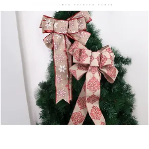 Linen Christmas bows with snowflake and damask patterns hanging on tree branches