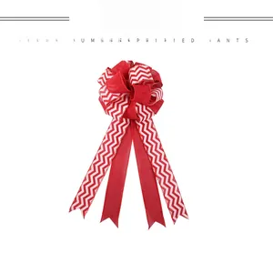 Detail view of a large red and white chevron pattern bow for Christmas tree decoration