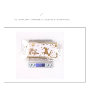 Close-up of Christmas ribbon with gold reindeer patterns on an electronic scale