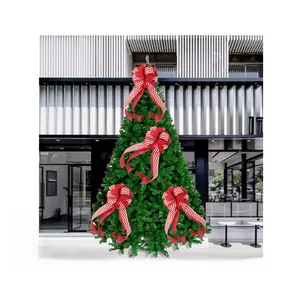 Detail view of red and white striped Christmas bows decorating a green festive tree