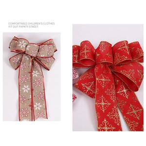 Close-up of rustic burlap snowflake bow and festive red gold glitter Christmas decoration