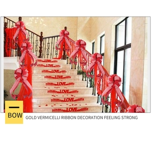 Detail of red and white wave pattern festive bow with mesh ribbon on a staircase