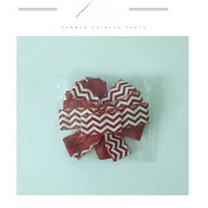 Detail of red and white wave pattern bow decoration in transparent plastic packaging