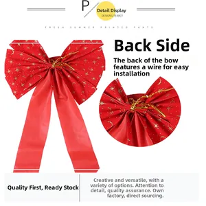 Detailed view of red Christmas bow with gold glitter stars and wire tie for easy mounting