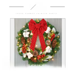 Detail of red Christmas bow with gold star and moon patterns on a festive holiday wreath