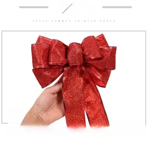 Detailed view of large red glitter Christmas bow ornament with wired edge for tree decor