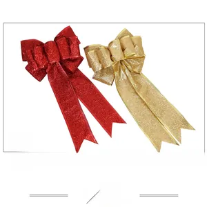 Detail of red and champagne gold glitter bows with double-layered festive ribbon texture