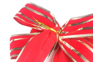 Macro detail of red festive bow with sparkling gold glitter stripes and secure metal wire
