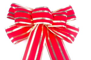 Close-up of red velvet Christmas bow with gold glitter stripes for tree decoration