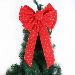 Red velvet Christmas tree bow with gold star patterns and moon motifs for holiday decor