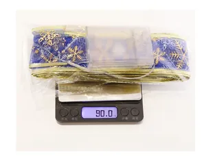 Blue LED Christmas ribbon with gold snowflakes showing product weight on scale
