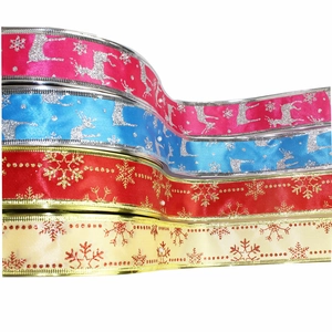 Close-up of glitter-printed Christmas ribbons with reindeer and snowflake patterns