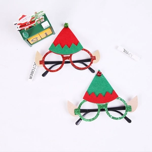 Detail shot of Christmas elf party glasses with glitter green frames and red felt hats