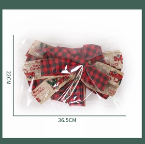 Detailed view of red buffalo plaid Christmas bow with rustic burlap and red truck pattern
