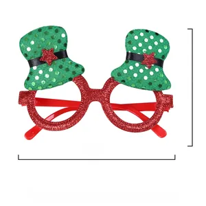 Detail of red glitter Christmas glasses frame with green festive hats and stars, 15x10cm