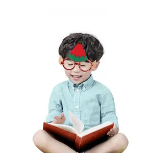 Macro shot of festive Christmas elf glasses with red glitter frame and elf hat for kids