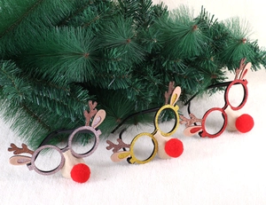 Close-up of glittery Christmas reindeer glasses with sequined antlers and red pom pom noses
