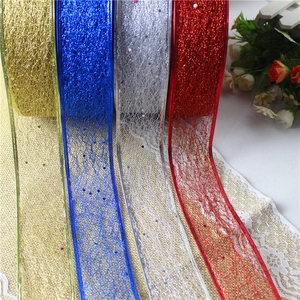 Close-up of glitter mesh Christmas ribbons in gold, blue, silver, and red colors