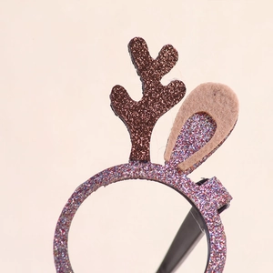 Close-up of Christmas reindeer antlers headband with brown glitter and soft felt ears