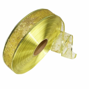 Golden translucent Christmas ribbon with glitter stars on a roll for tree decoration