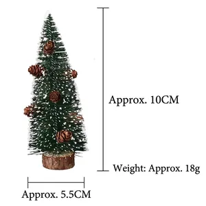 Detail view showing a 10cm mini frosted Christmas tree with pine cones and wood base