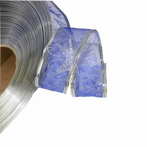 Macro shot of royal blue organza ribbon with silver glitter stars and metallic edges