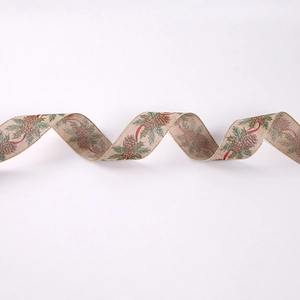 Close-up of burlap Christmas ribbon with pine cones, pine needles and gold wire edges