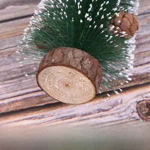 Macro shot of artificial Christmas tree featuring real pine cones and natural log base