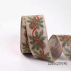Detail of Christmas burlap ribbon showing pine cones, green needles and gold wire edges