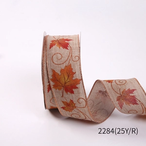 Detail of autumn maple leaf ribbon with metallic gold glitter edges and rustic texture