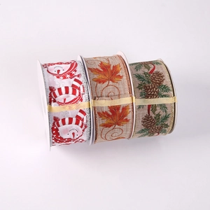 Close-up of festive Christmas ribbons with snowman, maple leaf and pinecone patterns