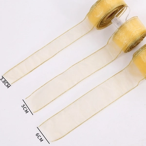 Golden shimmering organza ribbon in 3.8cm, 5cm and 6cm widths for Christmas tree decor