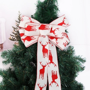 Linen Christmas tree bow topper with red reindeer pattern and decorative stitched edges